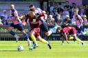 Chippenham Town's Cain Bradbury dribbles forward against Dulwich Hamlet