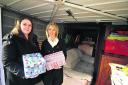 Samantha Burton, left, and Sharon Shackleford of Helping Survivors of Domestic Violence with some of the donations