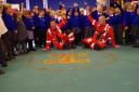 Wiltshire Air Ambulance paramedics Fred Thompson (left) and Paul Rock celebrating the pupils’ efforts in filling the H with coins