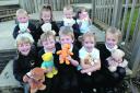 Priestley reception class pupils have a giggle while Abi, left, gives her teddy a lift
