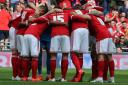 Swindon Town's players huddle before last season's League One play-off final at Wembley