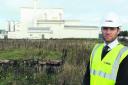 Ed Dodd, divisional director of Hills Waste, at the site of the planned renewable energy centre, with the Arla Foods Westbury Dairies in the background