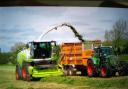 The forage harvester picking up, chopping and blowing grass into a trailer to be taken to the clamp and turned into silage