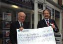 Geoffrey Taylor of Strakers gives a cheque for £604 to David Bartholomew of Help for Heroes’