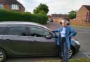Susan Sangston in front of her car