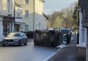 Overturned car closes busy High Street after crash