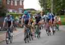 Sir Bradley Wiggins flanked by other Tour of Britain riders in Rushall