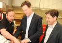 Lib Dem leader Nick Clegg tries his hand at making an alloy wheel with Craig  Butler and Duncan Hames, who is seeking re-election, during a visit to Dymag at Chippenham today. By Trevor Porter