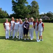 The Box ladies team who won the county women's team title for a record 10th successive seasons. Captain Alex Jacobs receives the trophy from county president Ruth Gerrish