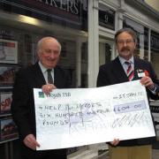 Geoffrey Taylor of Strakers gives a cheque for £604 to David Bartholomew of Help for Heroes’