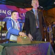 Christmas card design winner Zeon, aged ten,  presses the plunger to switch on Corsham lights, watched by town council chairman Steve Abbott. Photo: Trevor Porter 69442-12