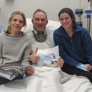 Chris Williams in hospital with his wife and daughter.