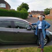 Susan Sangston in front of her car