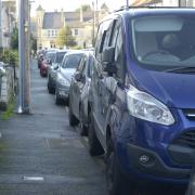 A row of cars parked on the pavements at West Street Trowbridge