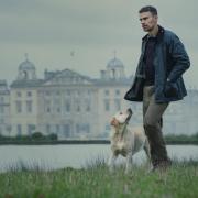 Theo James in front of Badminton House in a scene from The Gentlemen