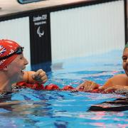 Stephanie Millward (left) is in to her fifth final after qualifying from her SM9 200m individual medley heat behind Natalie du Toit (right)