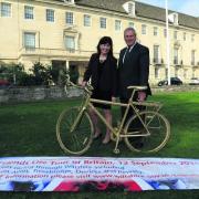 Wiltshire Council corporate director  Maggie Rae and deputy leader Coun John Thomson dep leader with one of the Golden Bikes that are being left around the route featuring messages of support. They are standing on the spot at County Hall.
