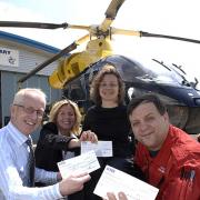 Andy Downes (left) makes his bodyshop's first charity tithe donations to (l-r) Annette Plaistow-Trapaud of the Hampshire & Isle of Wight Air Ambulance Service, Victoria Holton of the Southern Spinal Injuries Trust and helicopter paramedic Shaun Russell
