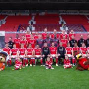 With the Swindon Town Football Club squad are Kevin Reed, head of operations at Wiltshire Air Ambulance, paramedic Steve Riddle, Wilber the mascot and paramedic Jo Munday