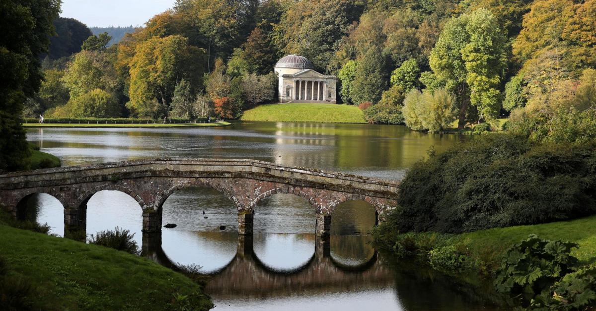 Autumn colours on display at Stourhead. Golden, orange and red hues beginning to appear in the trees including acers, tulip trees and American oaks. Picture by Andrew Matthews/PA Wire