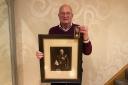Nigel Carter with his grandfather Joe Brain's George Medal and a photograph of him