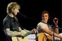Luke Gittins performs on stage with Ed Sheeran