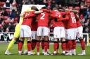 Swindon Town gather in a huddle before a home game