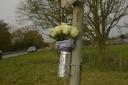 Floral tributes left at the A350 after a fatal crash