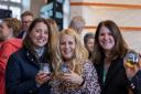 From left, Hannah Locke, Sian Winslade and Donna O'Keefe raise a glass as some of the many local businesses who sponsored the event