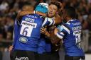 Bath's Rhys Priestland is mobbed as he celebrates scoring opening try against the Exeter Chiefs
