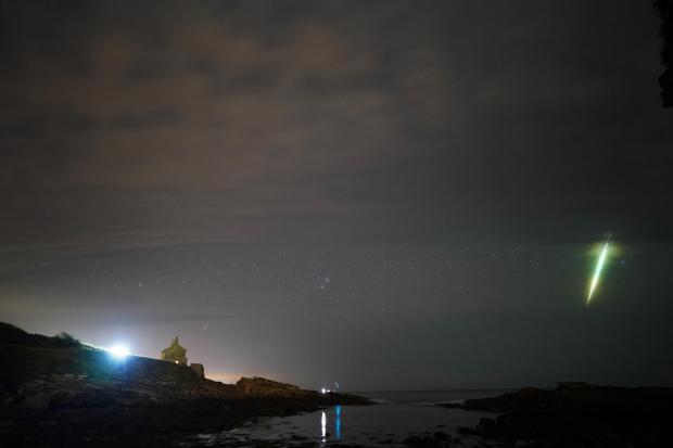 The Wiltshire Gazette and Herald: A fisherman watches a meteor during the Draconid meteor shower over Howick rocks in Northumberland. Picture date: Sunday October 10, 2021. Credit: PA