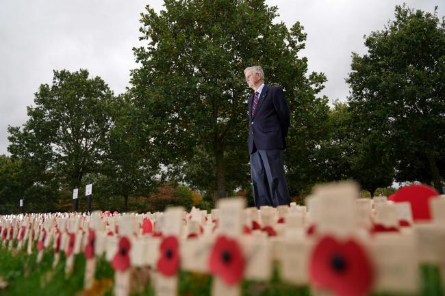 RAF veteran Mike Smith observes the planted tributes during the official opening of the 2021 Royal British Legion Field of Remembrance at the National Memorial Arboretum in Alrewas, Staffordshire. Credit: PA