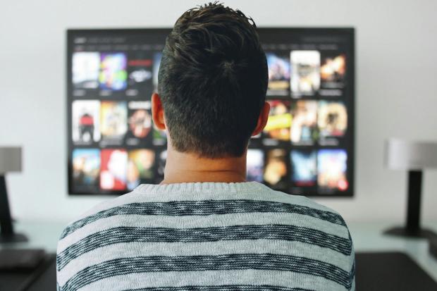 The Wiltshire Gazette and Herald: A man watching a smart TV. Credit: Canva