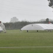 The players rush to get the covers on as the rain comes down during Purton’s clash at home to Calne             PICTURE: DAVE COX