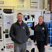 Chrissie and Mat Crossman in front of their new milk machine
