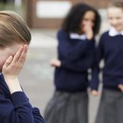 Stock image of a schoolgirl being bullied
