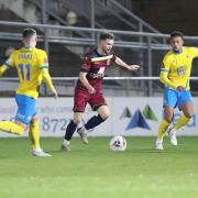 Action from last season's FA Trophy clash between Torquay United (yellow) and Chippenham Town