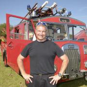 Firefighter Mark Truckle who brought the 1951 Dennis  fire engine to the show showing how fire engines used to look years ago.