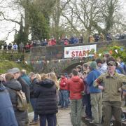Crowds applaud the early starters  to  Devizes to Westminster Canoe race.