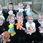 Priestley reception class pupils have a giggle while Abi, left, gives her teddy a lift