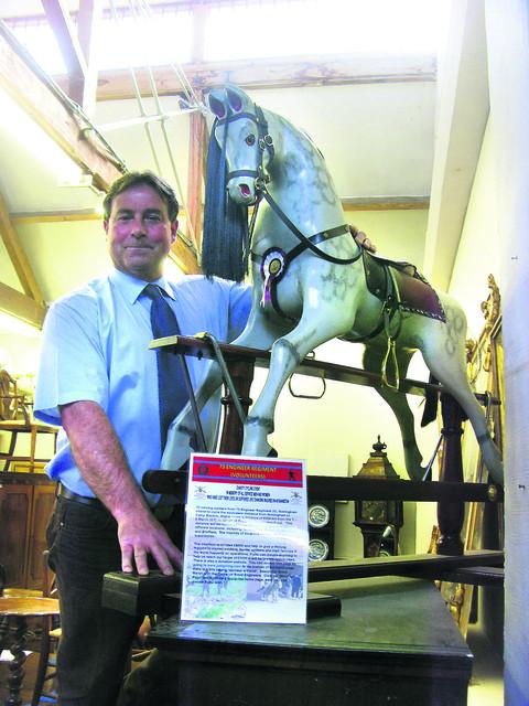 Gordon Brockman from Chippenham Auction Rooms with the rocking horse up for auction