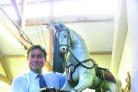 Gordon Brockman from Chippenham Auction Rooms with the rocking horse up for auction