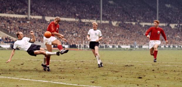The Wiltshire Gazette and Herald: ACTION: West Germany's Willi Schulz challenges England's Roger Hunt, watched by teammate Karl-Heinz Schnelling and England's Alan Ball