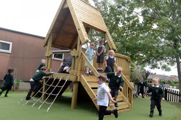 Reception children at Holym Trinity, Calne enjoy their new play area.  Photo: Siobhan Boyle SMB2524/3